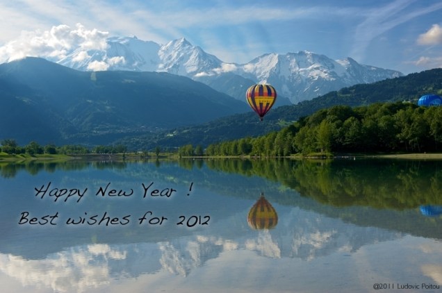 Hot balloon over lake with Mont Blanc in the back.